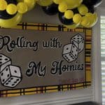 Bunco game night banner with yellow and black balloons for party decor.