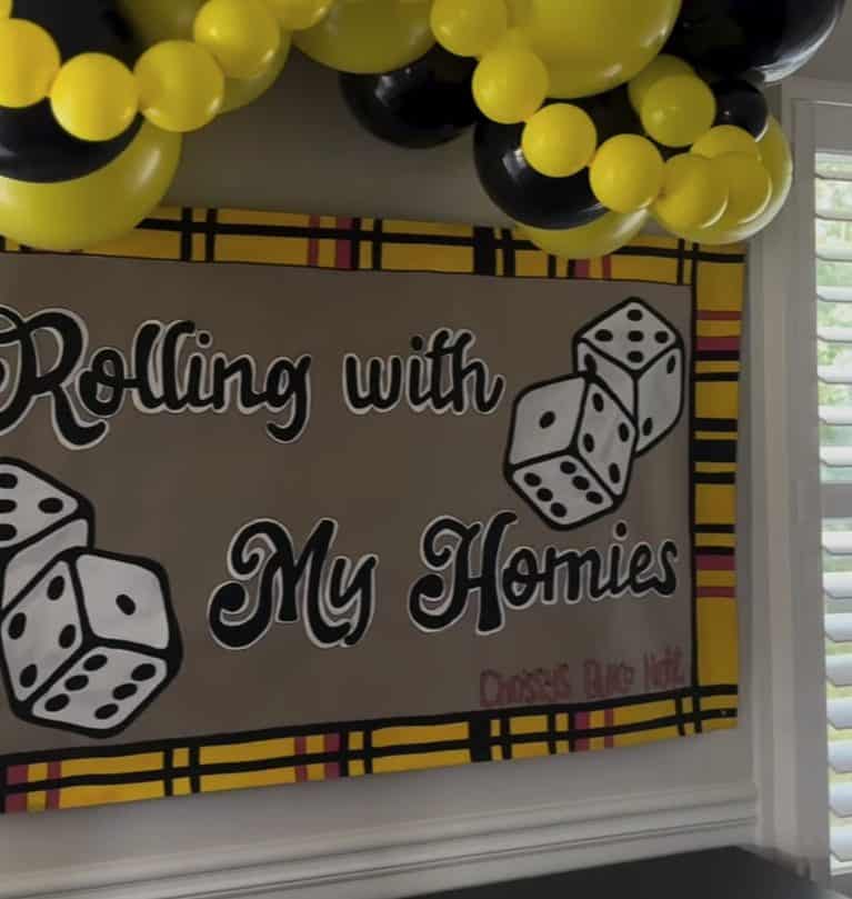 Bunco game night banner with yellow and black balloons for party decor.