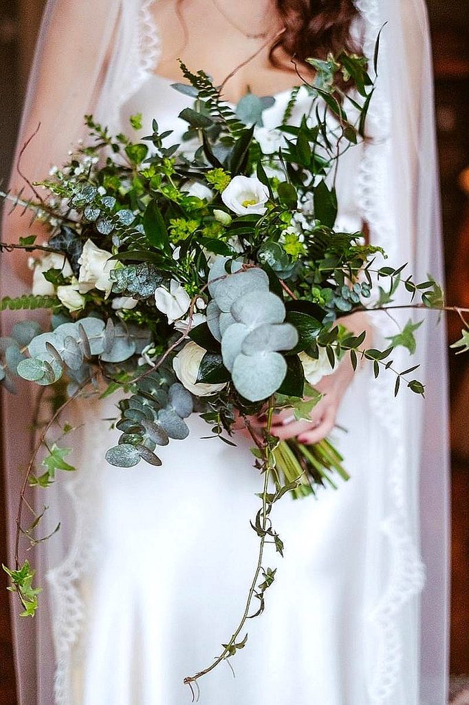 Elegant bridal bouquet with white flowers and lush greenery for winter wedding.