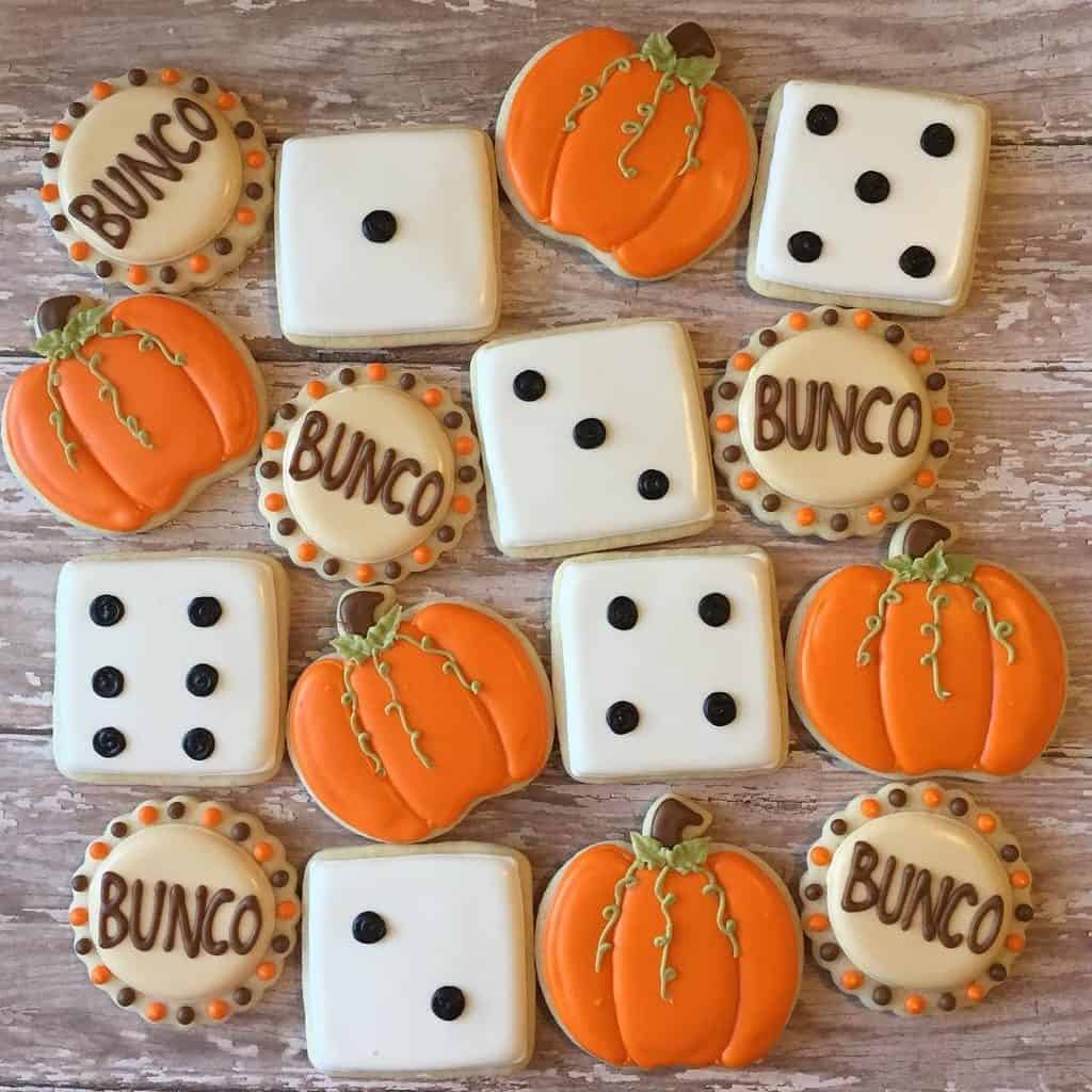 Bunco-themed cookies and dice for a Bunco party with pumpkin decorations.